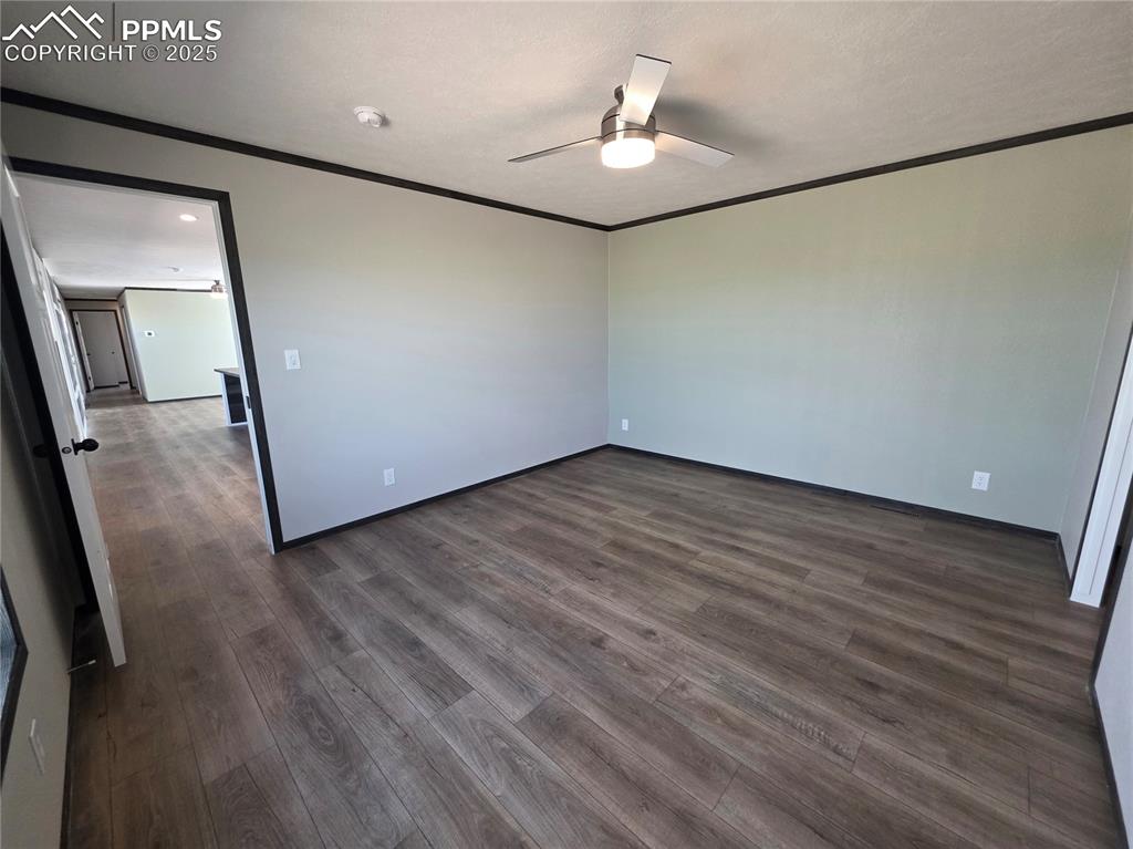 6685 Ramah Highway Yoder, CO 80864 - Photo 16 of 30 a view of an empty room with wooden floor and a window