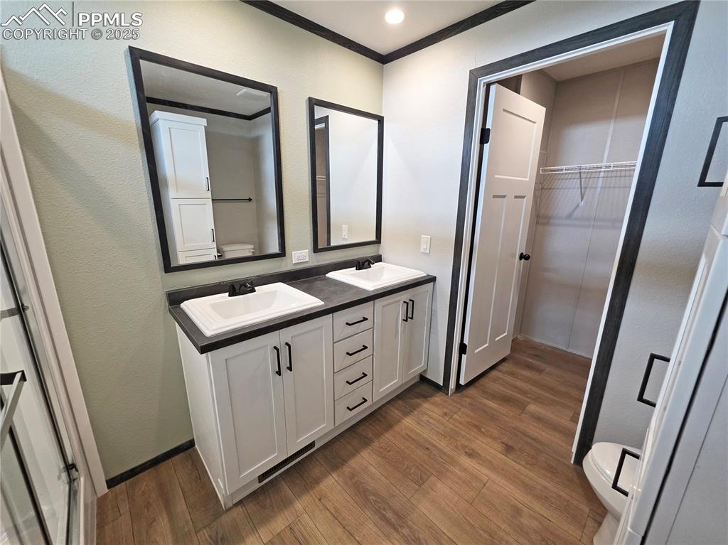 6685 Ramah Highway Yoder, CO 80864 - Photo 17 of 30 a bathroom with a double vanity sink and mirror