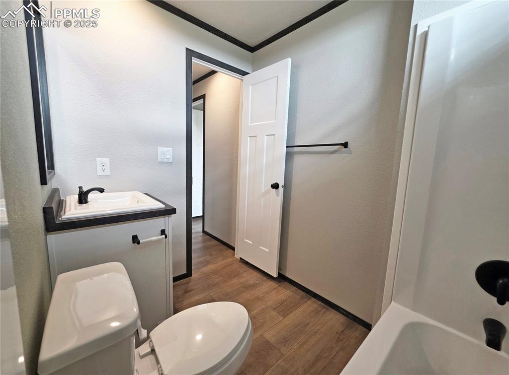 6685 Ramah Highway Yoder, CO 80864 - Photo 24 of 30 a bathroom with a sink and mirror with toilet