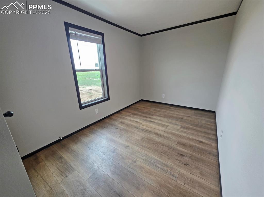 6685 Ramah Highway Yoder, CO 80864 - Photo 25 of 30 a view of an empty room with wooden floor and a window