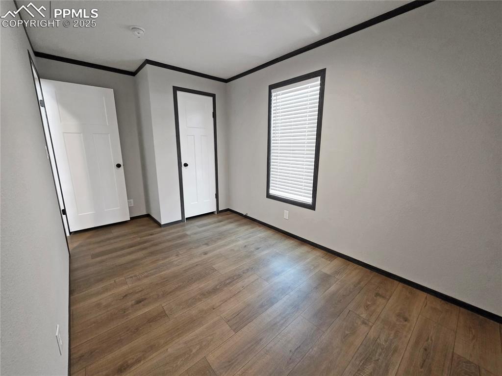 6685 Ramah Highway Yoder, CO 80864 - Photo 26 of 30 an empty room with wooden floor and windows