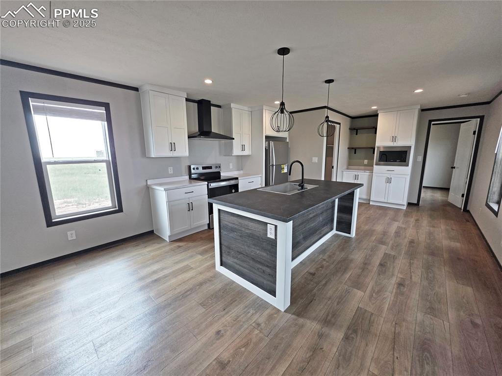 6685 Ramah Highway Yoder, CO 80864 - Photo 9 of 30 a kitchen with a sink stove and wooden floor