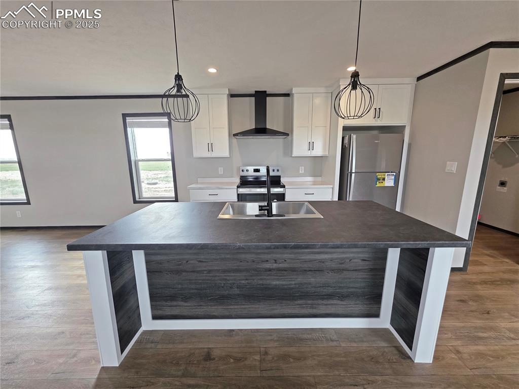 6685 Ramah Highway Yoder, CO 80864 - Photo 10 of 30 a kitchen view with wooden floor and a refrigerator