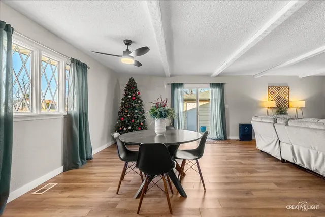 a view of a dining room with furniture window and wooden floor