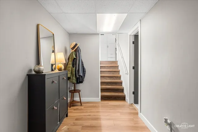 a view of a hallway with wooden floor and entryway