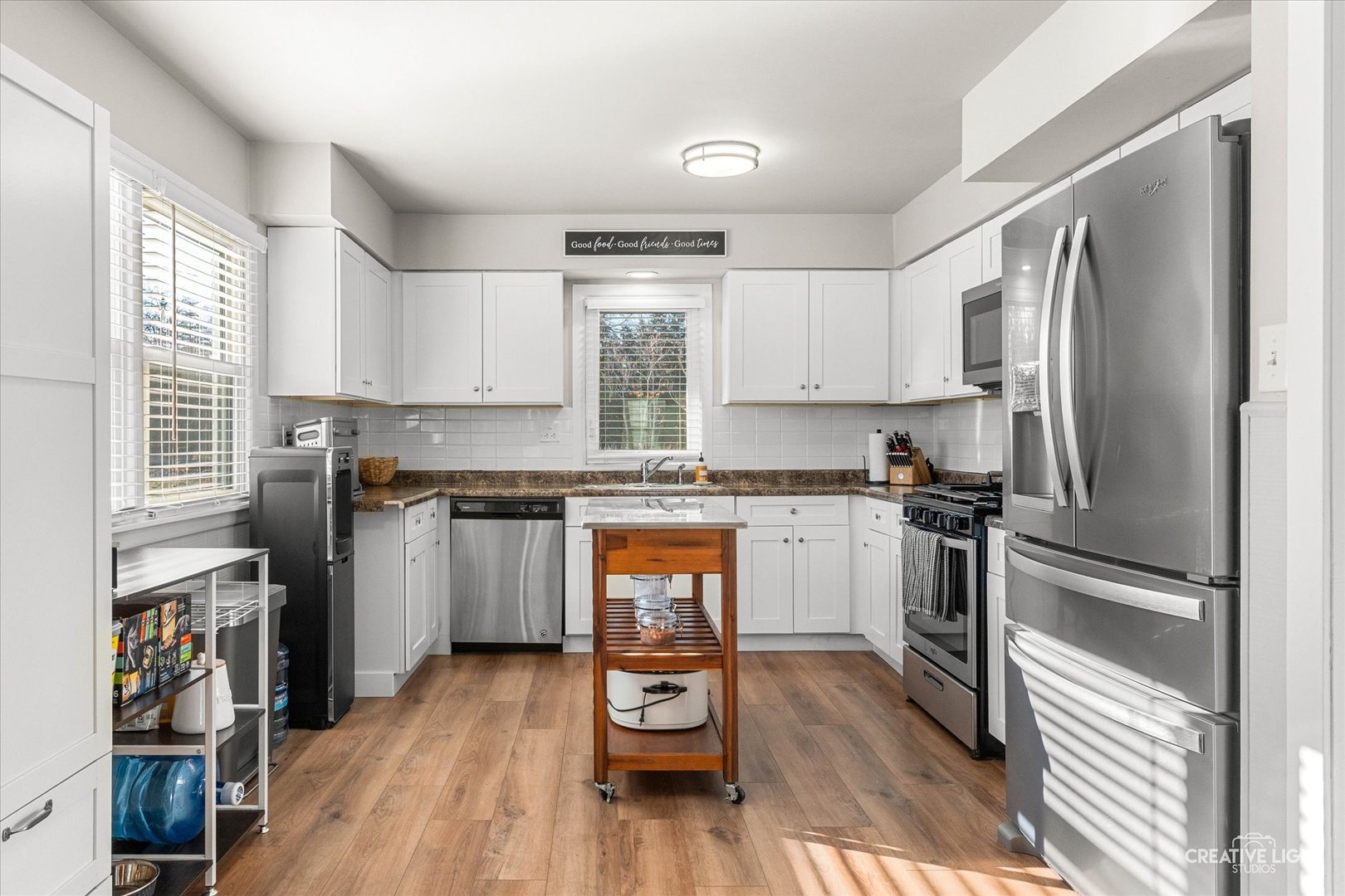 545 Gordon Drive Crete, IL 60417 - Photo 6 of 24 a kitchen with a refrigerator wooden floor and a window