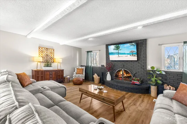 a living room with furniture a flat screen tv and potted plant