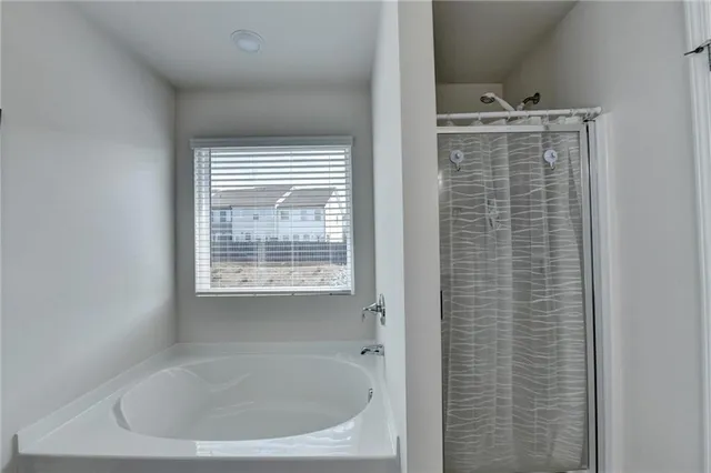 a back yard of a house with table and chairs