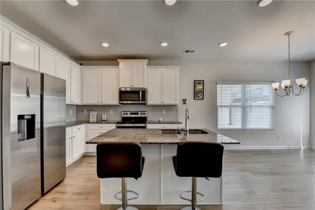 a kitchen with stainless steel appliances granite countertop a granite counter tops and a refrigerator