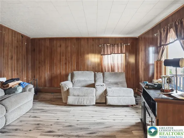 a room with water heater and a wooden floor