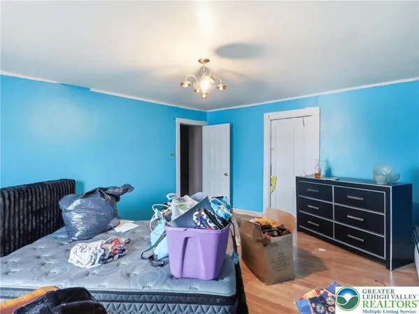 a bedroom with a bed and a dresser