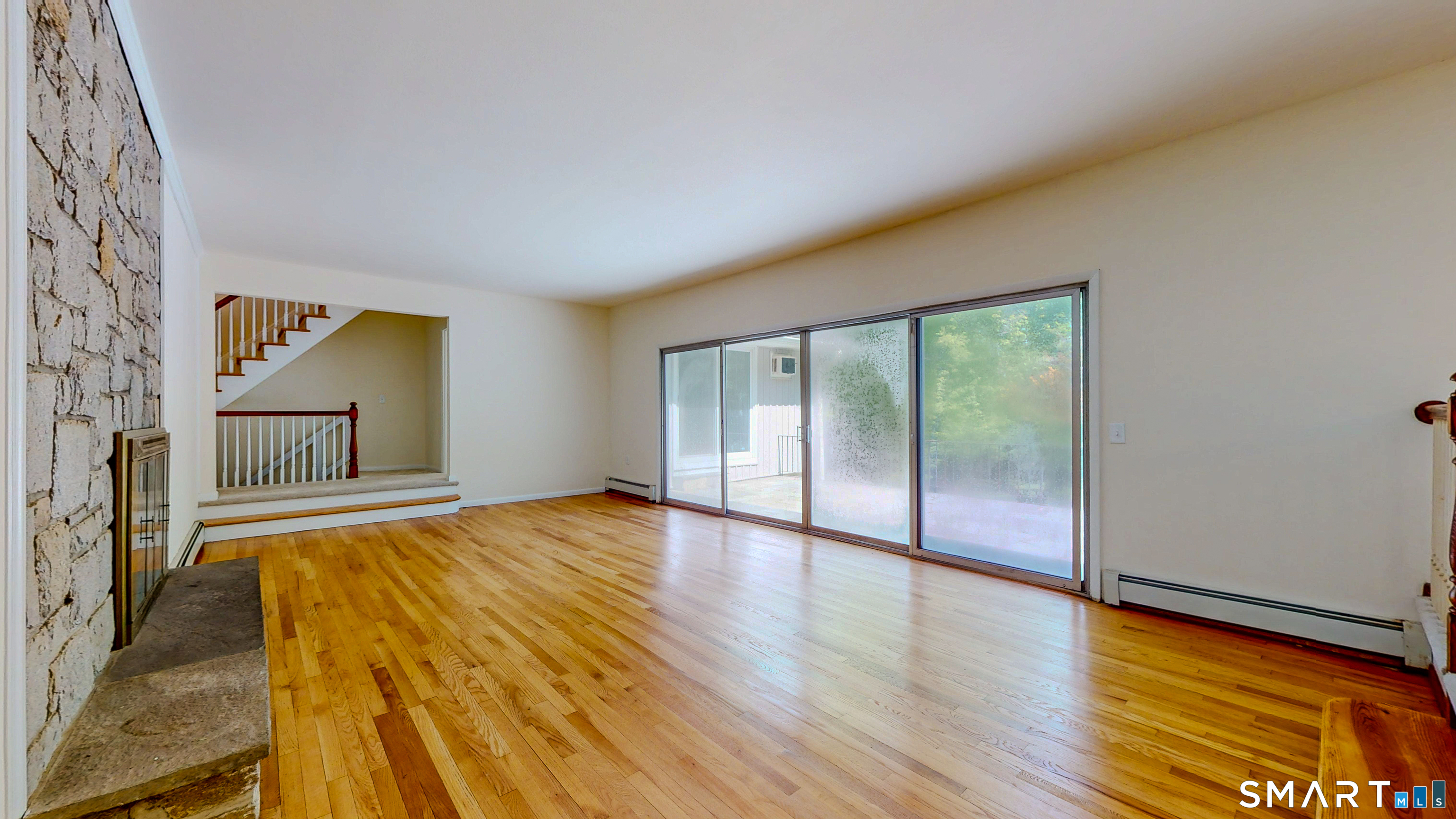 133 Chambers Road Danbury, CT 06811 - Photo 12 of 30 a bedroom with a bed and wooden floor