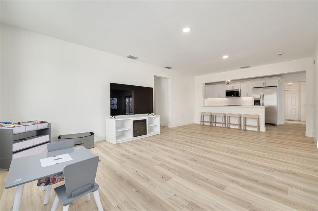 5531 Manatee Point Drive New Port Richey, FL 34652 - Photo 11 of 61 a living room with furniture and a flat screen tv