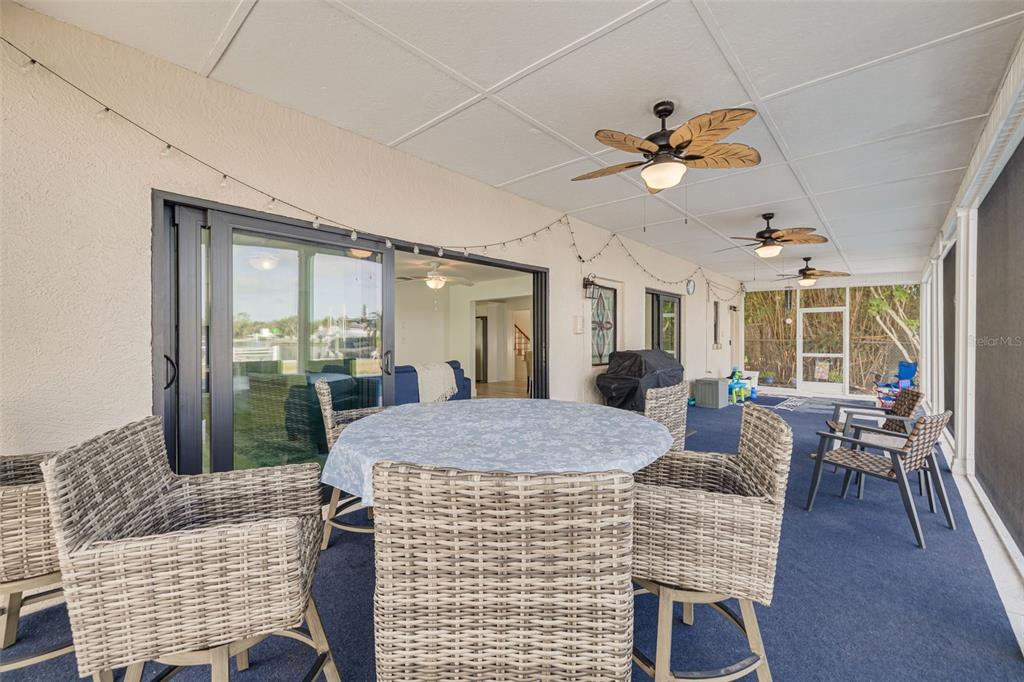 5531 Manatee Point Drive New Port Richey, FL 34652 - Photo 15 of 61 a dining room with large window table and chairs