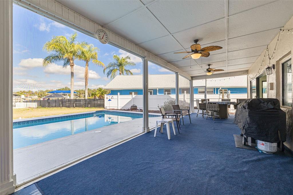 5531 Manatee Point Drive New Port Richey, FL 34652 - Photo 17 of 61 a view of a swimming pool with a large window
