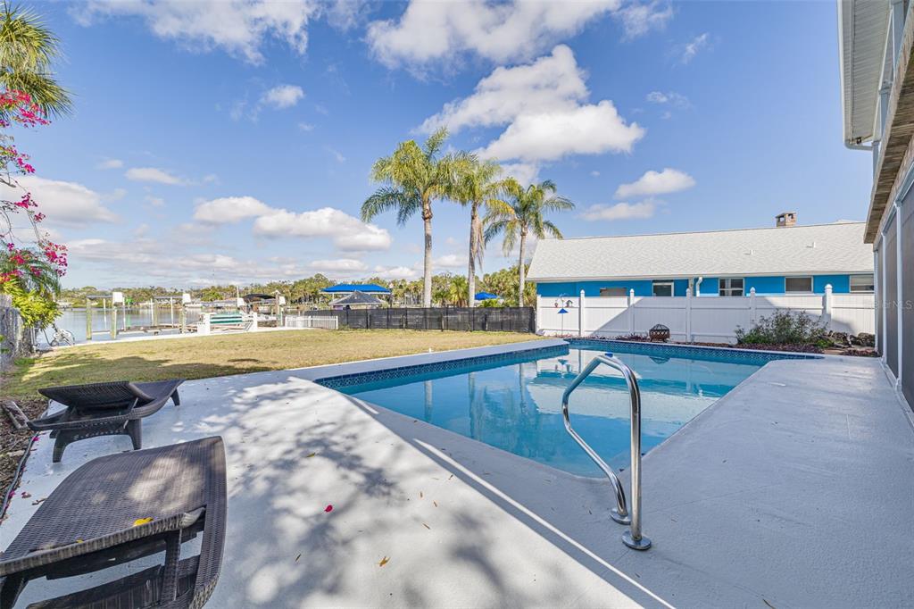 5531 Manatee Point Drive New Port Richey, FL 34652 - Photo 19 of 61 a view of a swimming pool with an outdoor seating