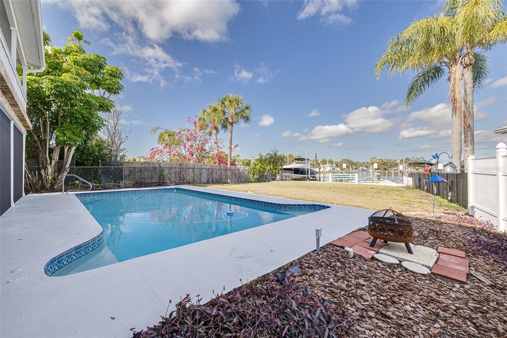 5531 Manatee Point Drive New Port Richey, FL 34652 - Photo 20 of 61 a view of a swimming pool with a lounge chairs