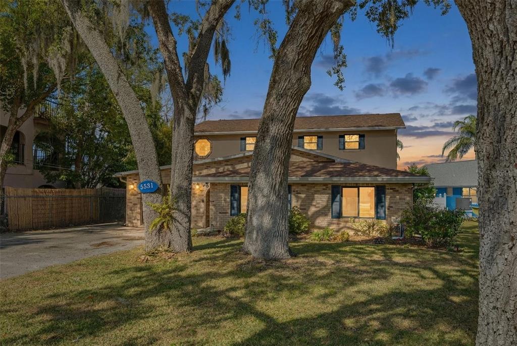 5531 Manatee Point Drive New Port Richey, FL 34652 - Photo 2 of 61 a front view of a house with a yard