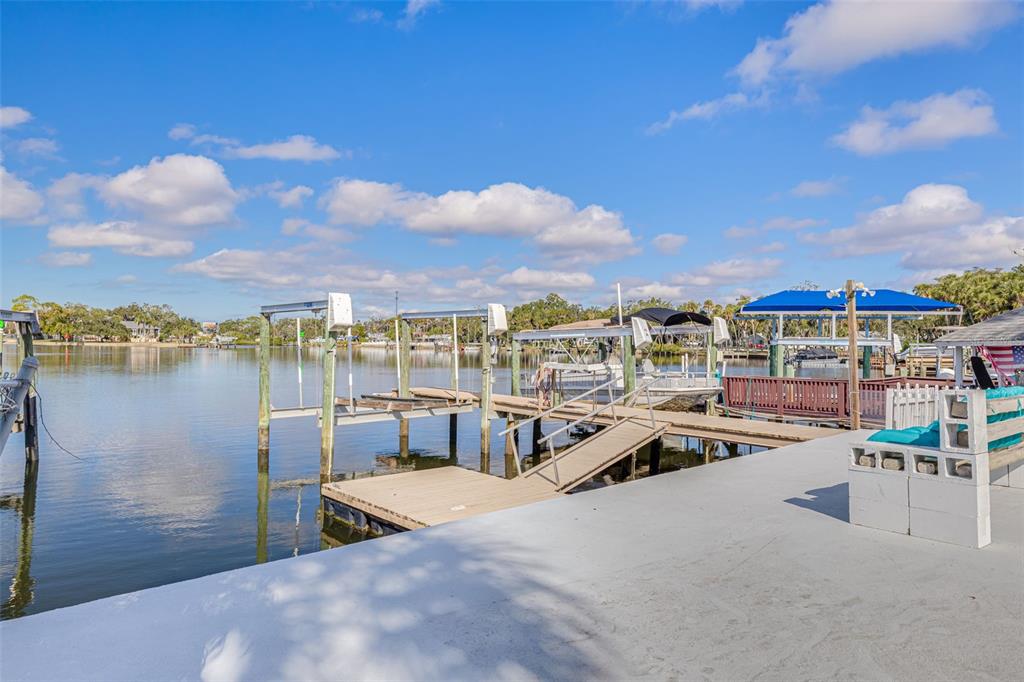 5531 Manatee Point Drive New Port Richey, FL 34652 - Photo 23 of 61 a view of a lake with outdoor seating