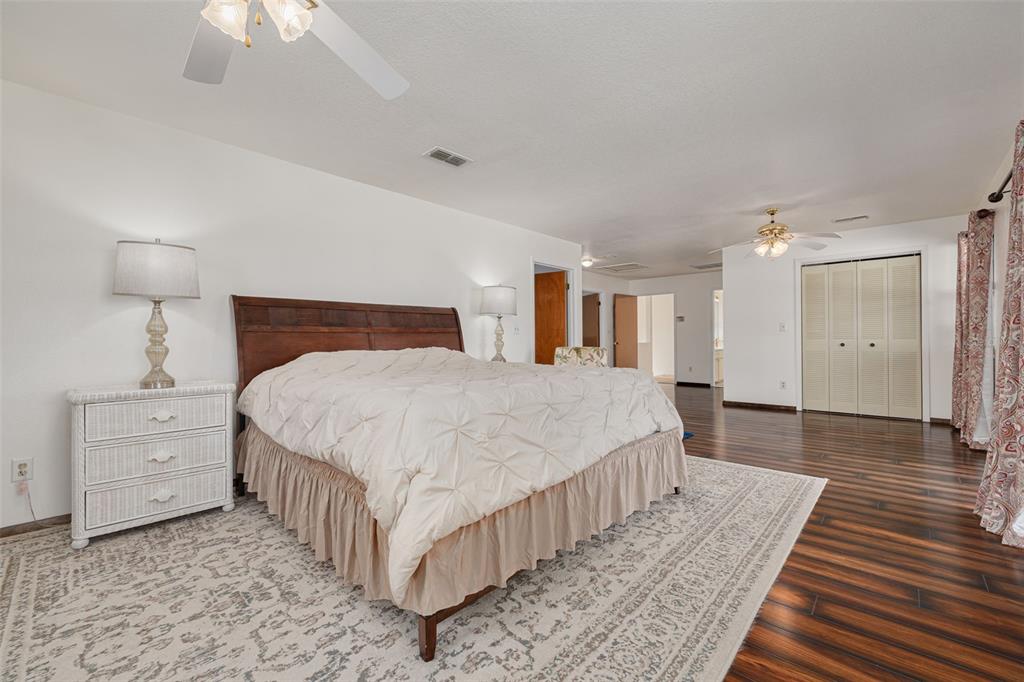 5531 Manatee Point Drive New Port Richey, FL 34652 - Photo 28 of 61 a bedroom with a bed and a chandelier