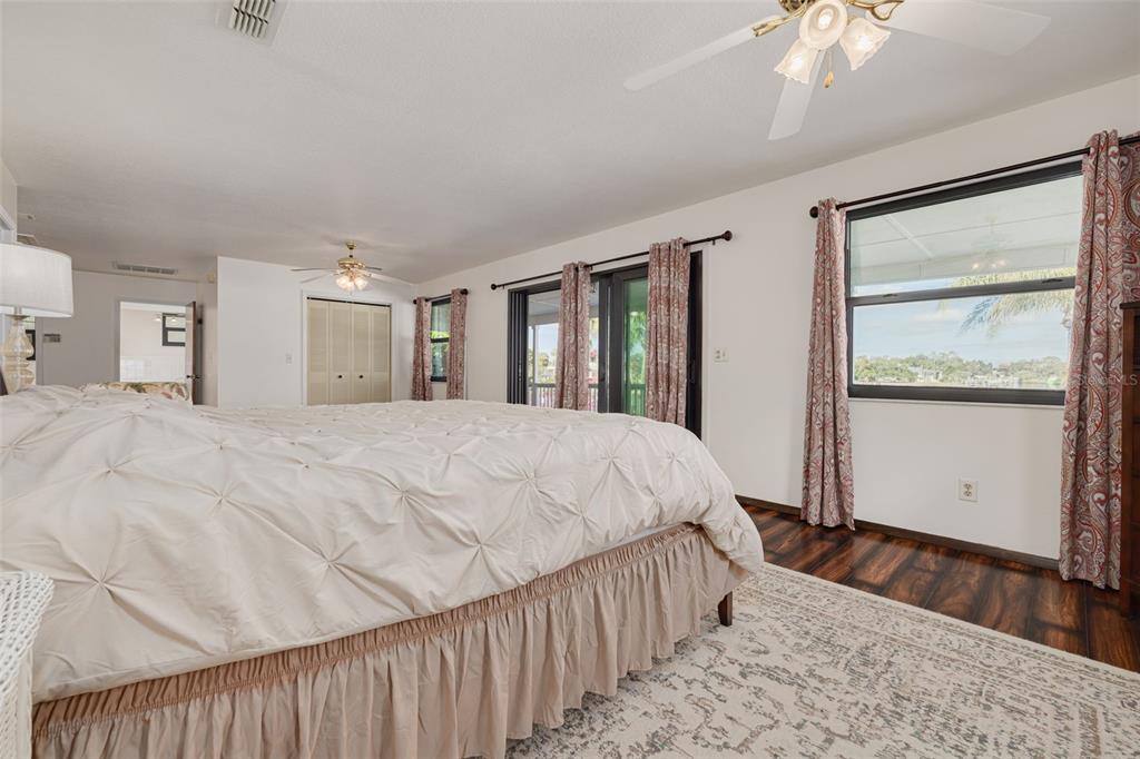 5531 Manatee Point Drive New Port Richey, FL 34652 - Photo 29 of 61 a large bed sitting in a bedroom next to a window