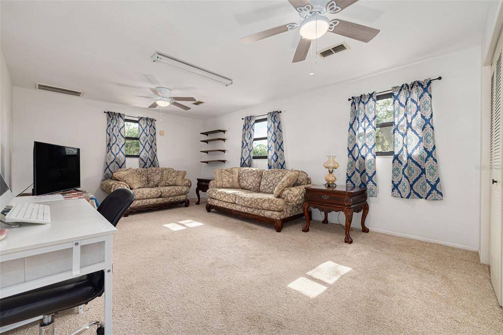 5531 Manatee Point Drive New Port Richey, FL 34652 - Photo 38 of 61 a living room with furniture and a flat screen tv