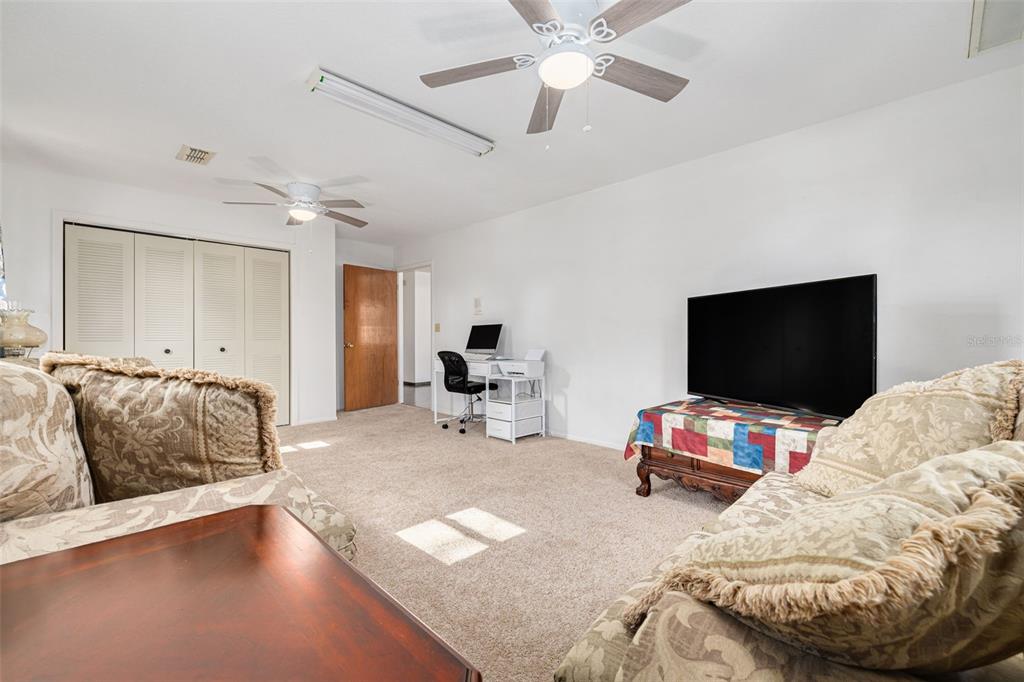 5531 Manatee Point Drive New Port Richey, FL 34652 - Photo 39 of 61 a living room with furniture and a flat screen tv