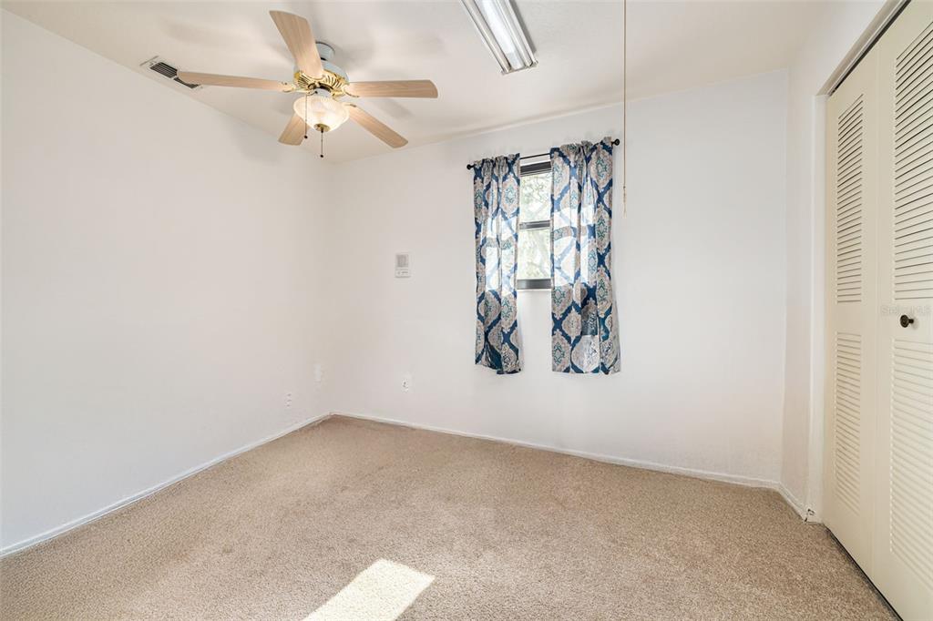 5531 Manatee Point Drive New Port Richey, FL 34652 - Photo 40 of 61 an empty room with a window and a fan