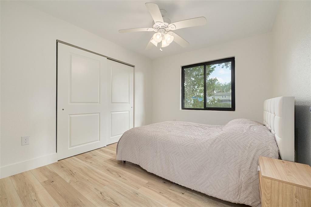 5531 Manatee Point Drive New Port Richey, FL 34652 - Photo 41 of 61 a bedroom with a bed and a chandelier