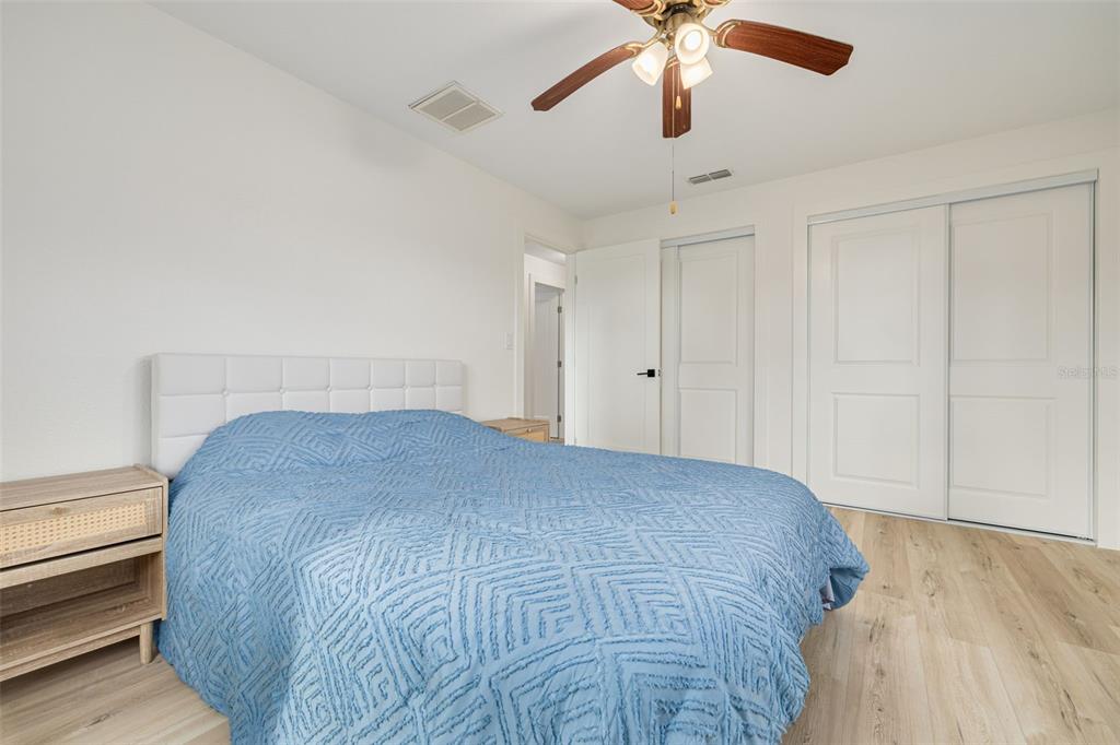 5531 Manatee Point Drive New Port Richey, FL 34652 - Photo 45 of 61 a bedroom with a bed and a ceiling fan