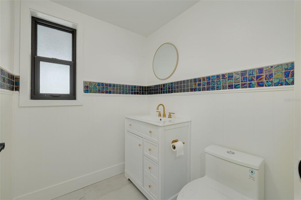 5531 Manatee Point Drive New Port Richey, FL 34652 - Photo 49 of 61 a bathroom with a toilet a sink and a window