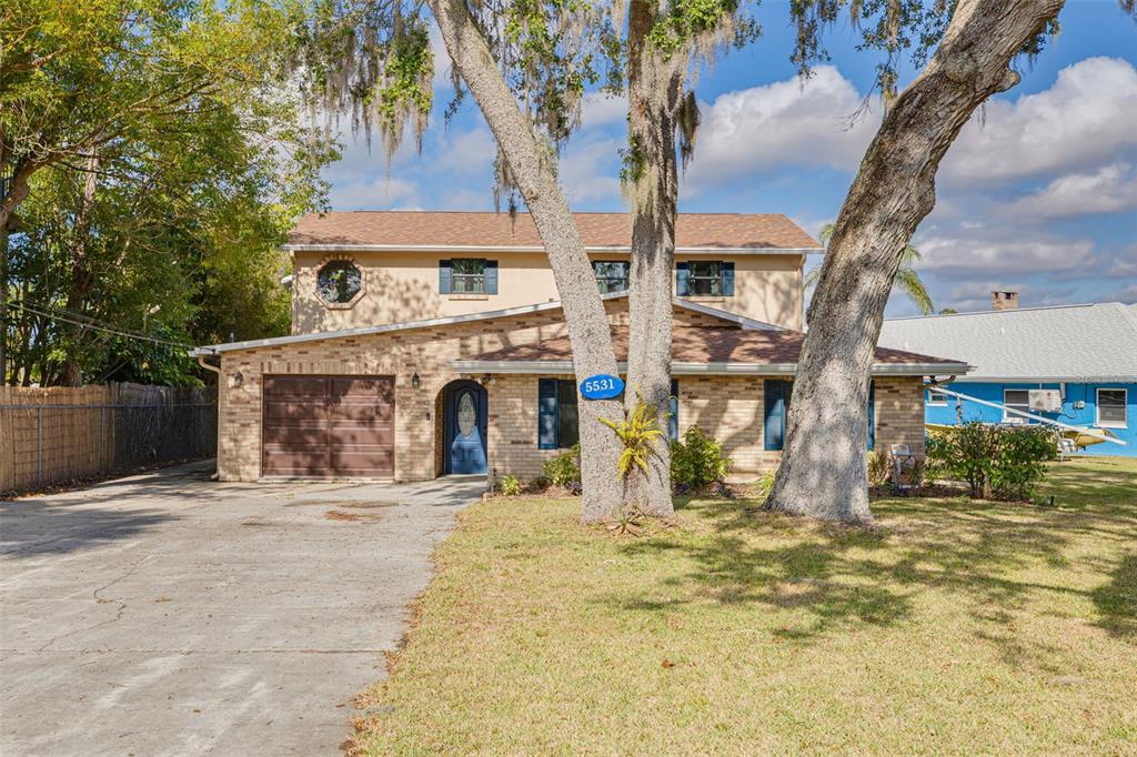 5531 Manatee Point Drive New Port Richey, FL 34652 - Photo 54 of 61 a front view of a house with yard