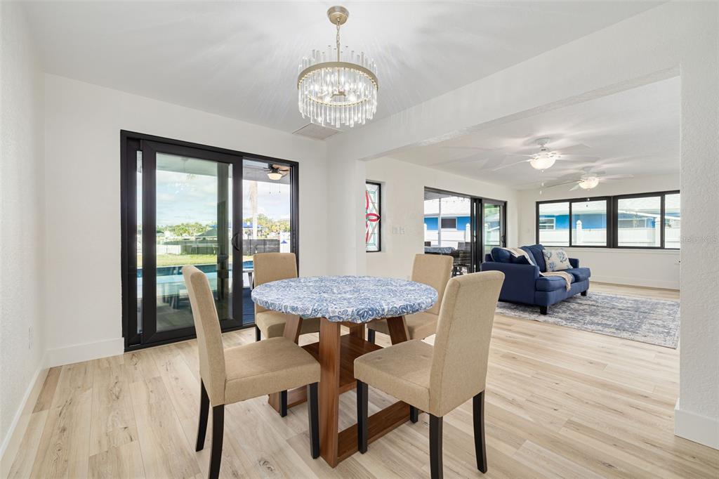 5531 Manatee Point Drive New Port Richey, FL 34652 - Photo 9 of 61 a view of a dining room with furniture window and wooden floor