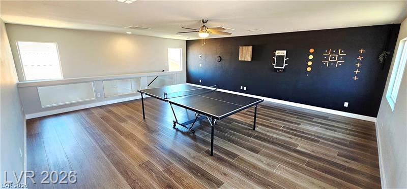 6302 Jackson Spring Road Las Vegas, NV 89118 - Photo 38 of 48 A spacious game room features durable wood flooring and a refreshing ceiling fan.
