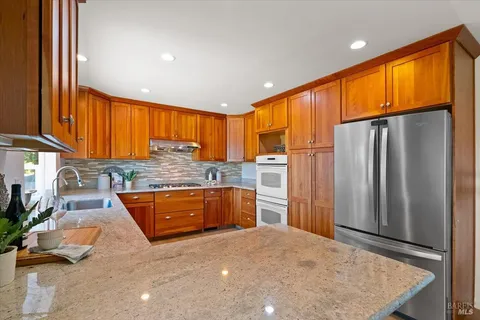 a view of a kitchen with a sink and a refrigerator