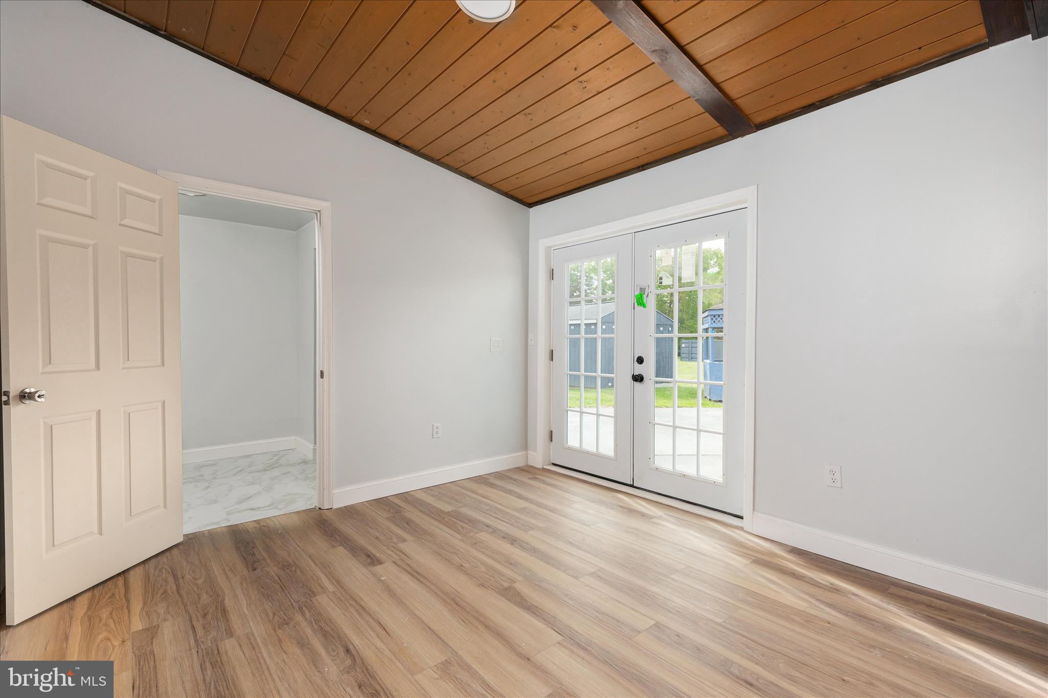 64 Shickle Lane Inwood, WV 25428 - Photo 21 of 42 an empty room with wooden floor and windows