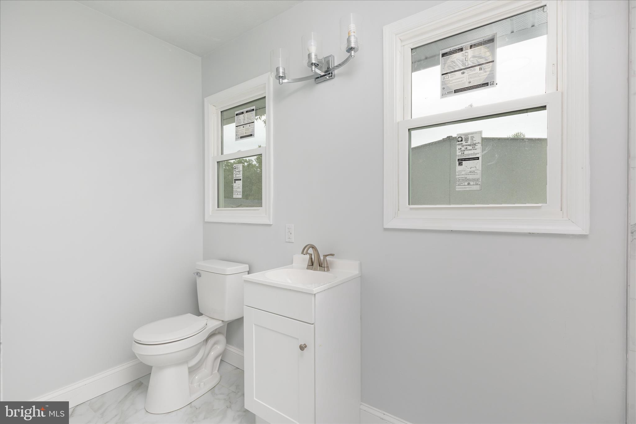 64 Shickle Lane Inwood, WV 25428 - Photo 29 of 42 a bathroom with a toilet sink vanity and mirror