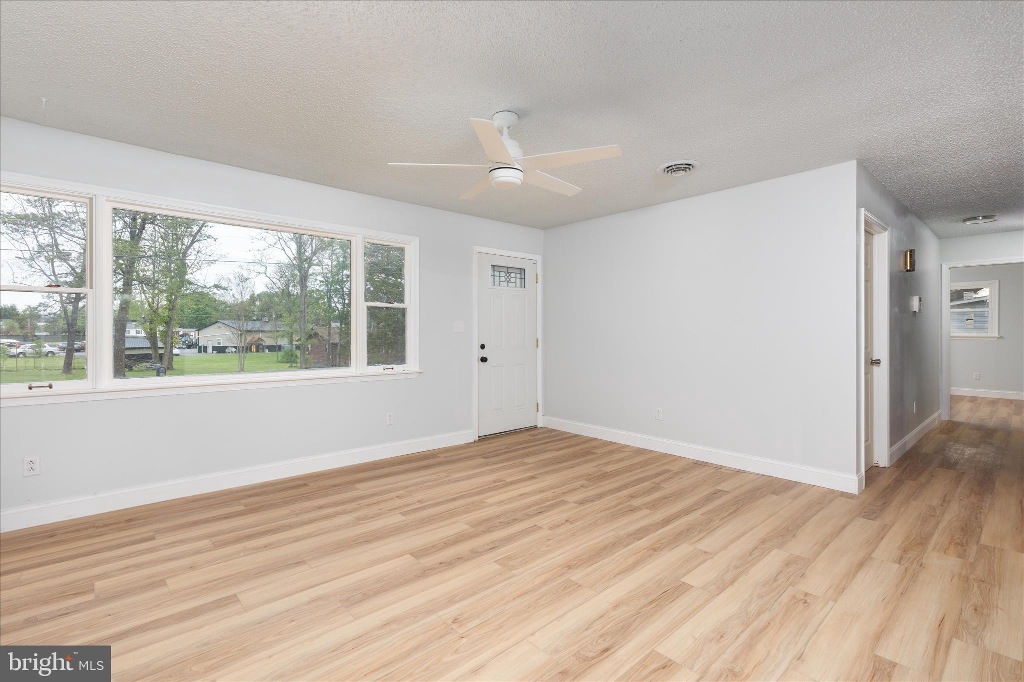 64 Shickle Lane Inwood, WV 25428 - Photo 4 of 42 a view of empty room with wooden floor and fan