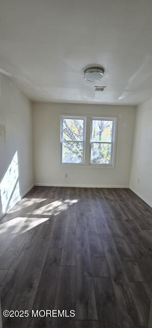 523 State Street Perth Amboy, NJ 08861 - Photo 11 of 12 an empty room with wooden floor and windows