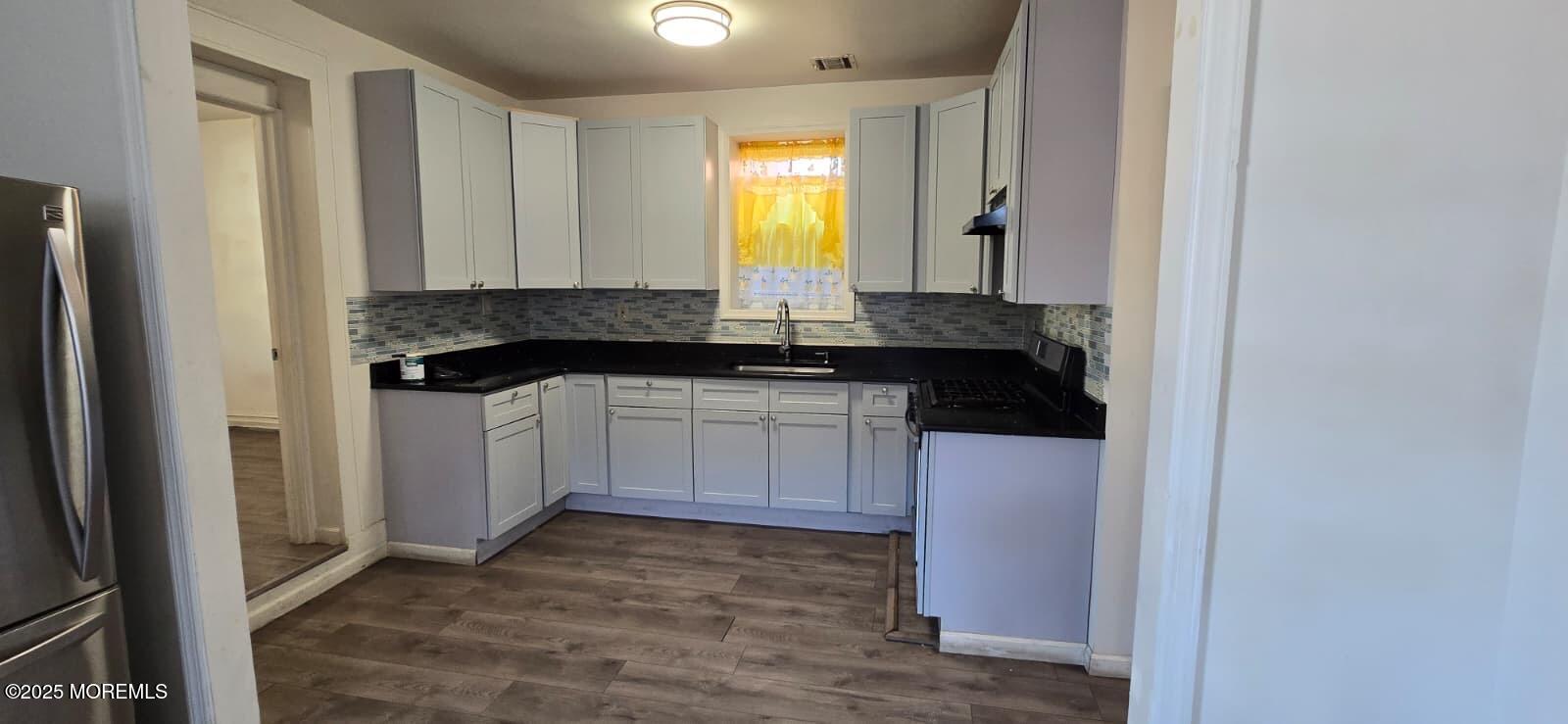 523 State Street Perth Amboy, NJ 08861 - Photo 2 of 12 a kitchen with a sink stove and cabinets