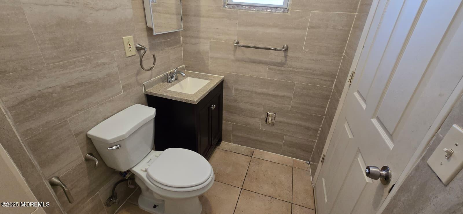 523 State Street Perth Amboy, NJ 08861 - Photo 7 of 12 a bathroom with a sink and a toilet