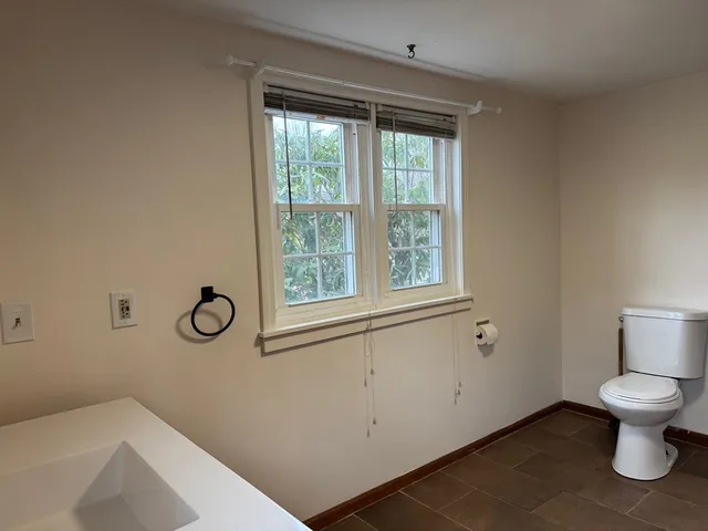 a bathroom with a toilet and a sink