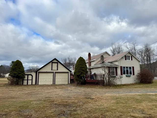 a view of house with outdoor space and swimming pool