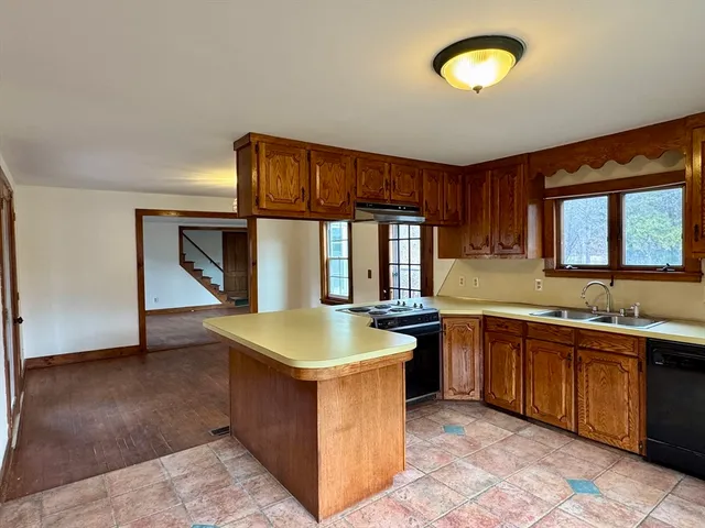 a kitchen with sink and cabinets