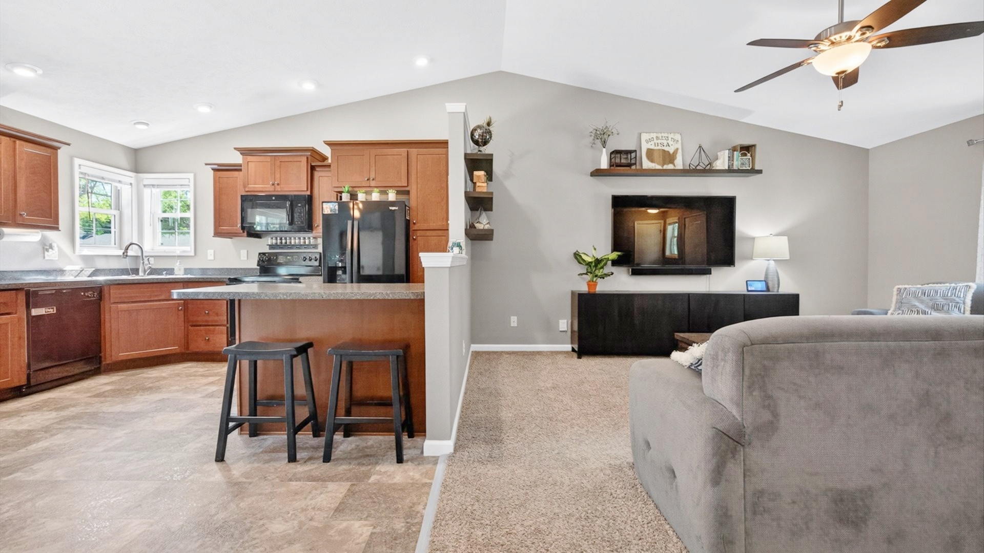 308 East Locust Street Normal, IL 61761 - Photo 10 of 40 a large living room with stainless steel appliances kitchen island granite countertop furniture and a fireplace