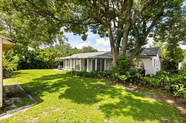 a front view of a house with yard and green space