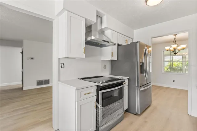 a kitchen with stainless steel appliances white cabinets and a sink
