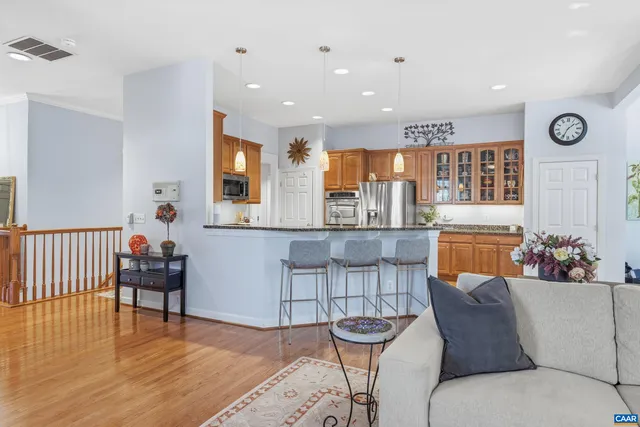 a kitchen with stainless steel appliances granite countertop a sink stove and microwave