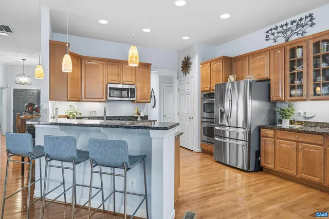 a spacious bathroom with a granite countertop sink a mirror and a bathtub