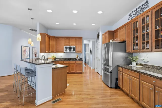 a kitchen with stainless steel appliances a stove a refrigerator and a sink